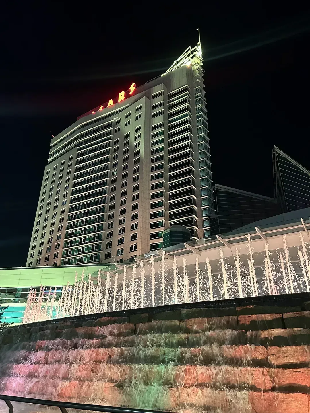 Waterfront hotel exterior beside the river at dusk